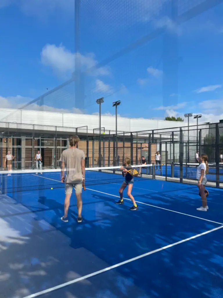 Children playing padel on the outdoor court